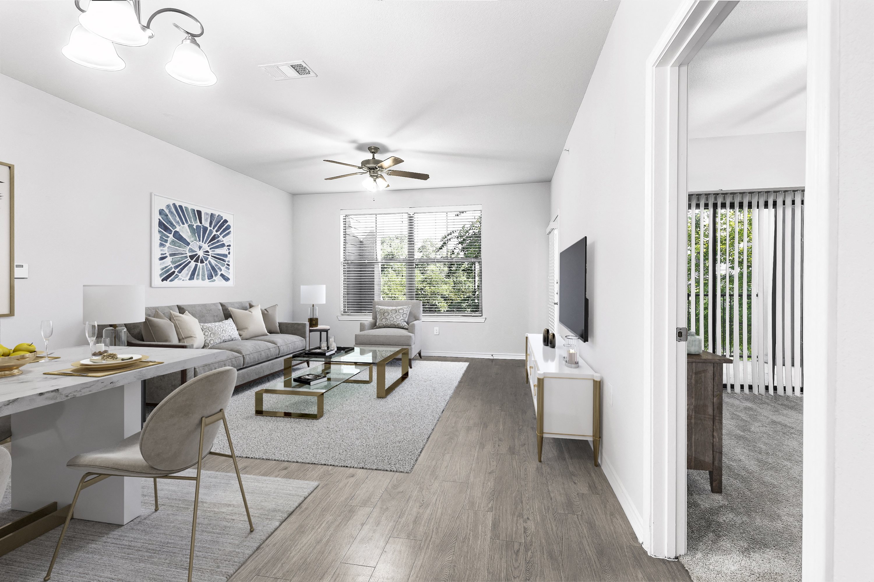 a living room with white walls and a ceiling fan